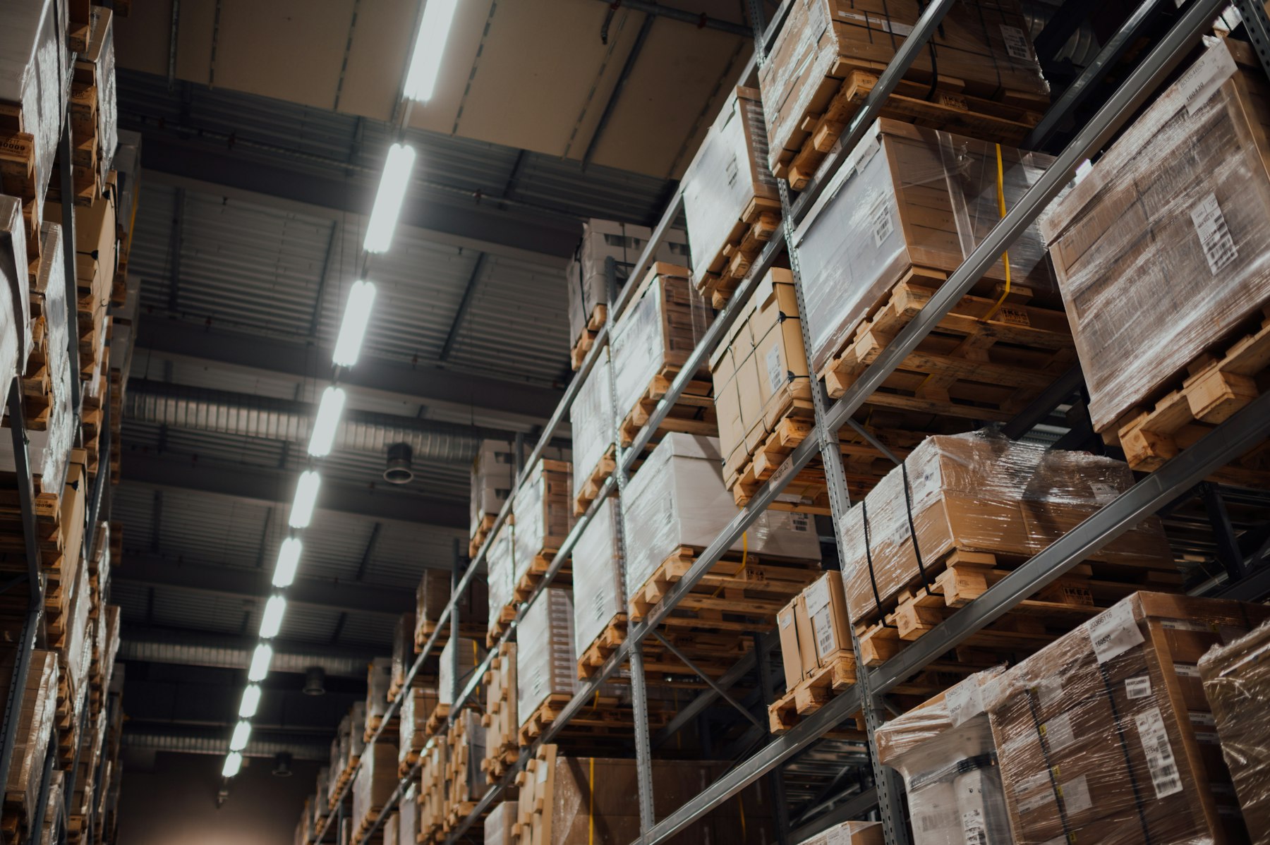 Tall warehouse racks filled with labelled pallet boxes