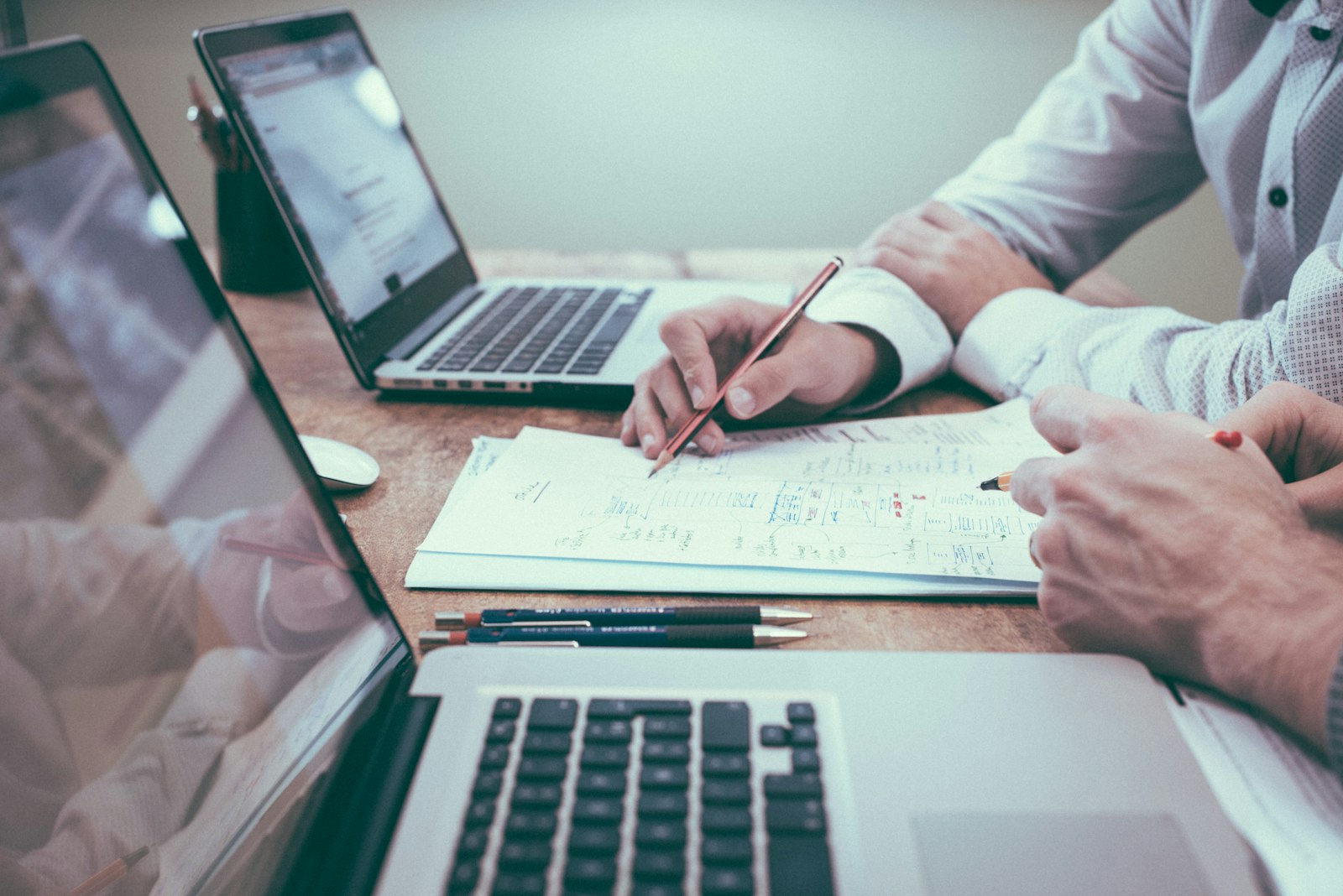 Cross-functional planning with charts, notes, and laptops