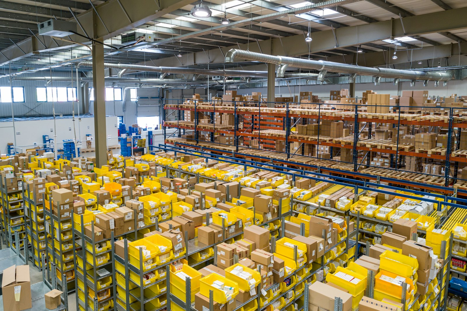 Large bright warehouse with pick bins and pallet racks